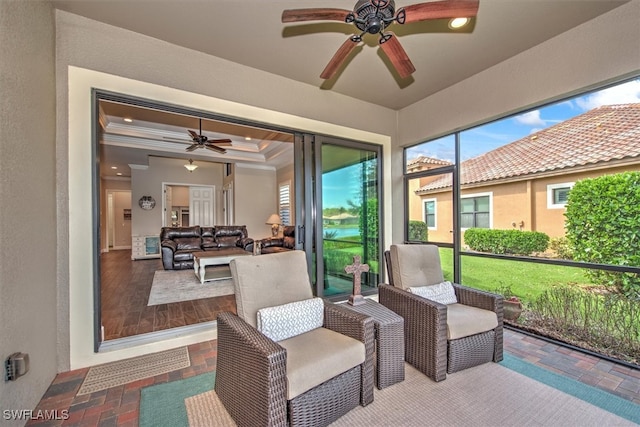 sunroom featuring ceiling fan