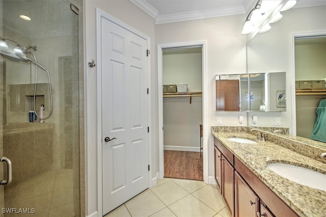 bathroom featuring vanity, ornamental molding, an enclosed shower, and tile patterned flooring