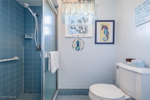 bathroom featuring a stall shower and toilet