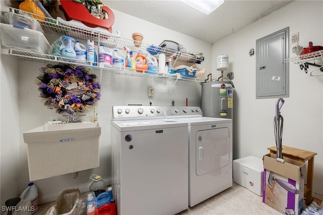 clothes washing area featuring a textured ceiling, laundry area, a sink, electric panel, and washing machine and clothes dryer