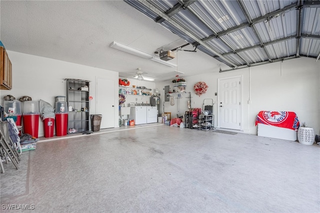 garage featuring a garage door opener and washer and dryer