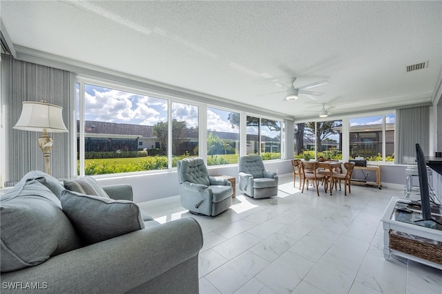 sunroom with ceiling fan and visible vents