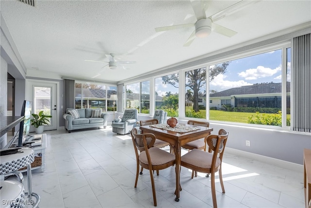 sunroom with a healthy amount of sunlight and ceiling fan