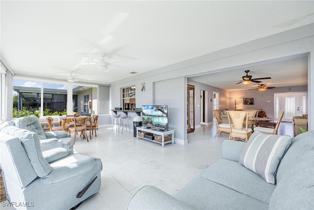 living room with ceiling fan, visible vents, baseboards, marble finish floor, and french doors