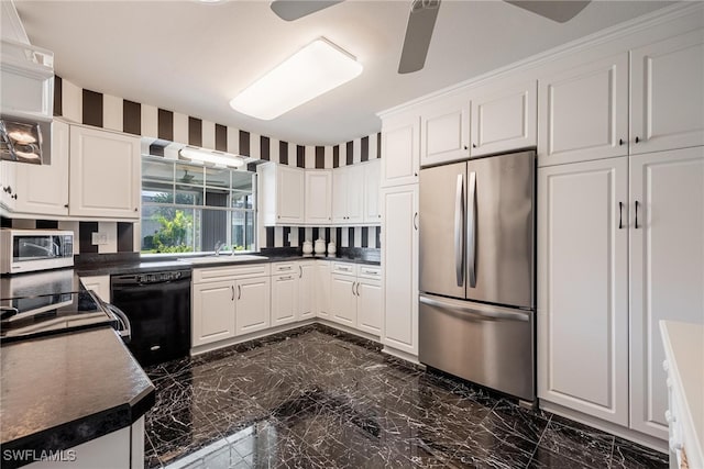 kitchen with freestanding refrigerator, black dishwasher, white cabinets, and dark countertops