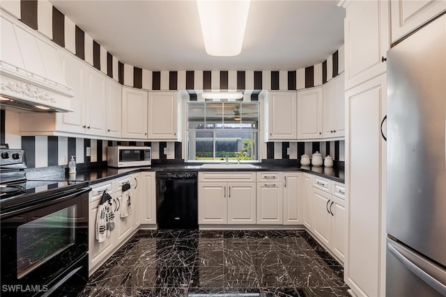 kitchen featuring wallpapered walls, dark countertops, black appliances, white cabinetry, and a sink