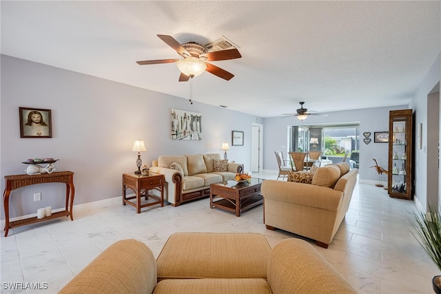 living room with a ceiling fan, marble finish floor, and baseboards