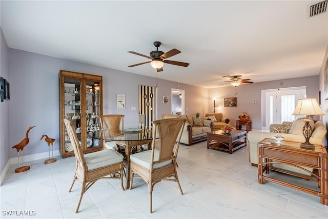 dining area featuring baseboards, marble finish floor, visible vents, and a ceiling fan