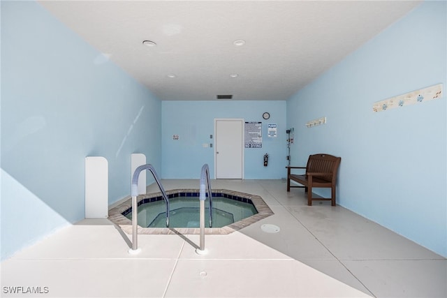 view of swimming pool featuring an indoor in ground hot tub