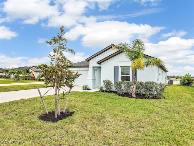 single story home featuring a front lawn and a garage