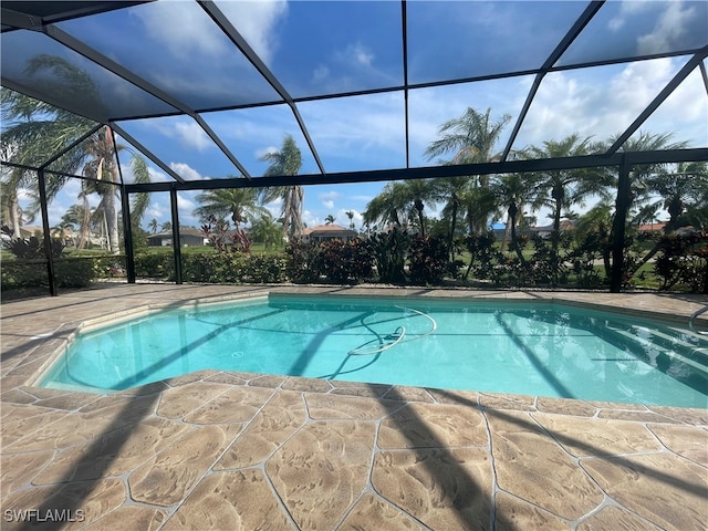 view of pool with a lanai and a patio