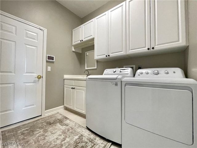 laundry room featuring cabinets and independent washer and dryer