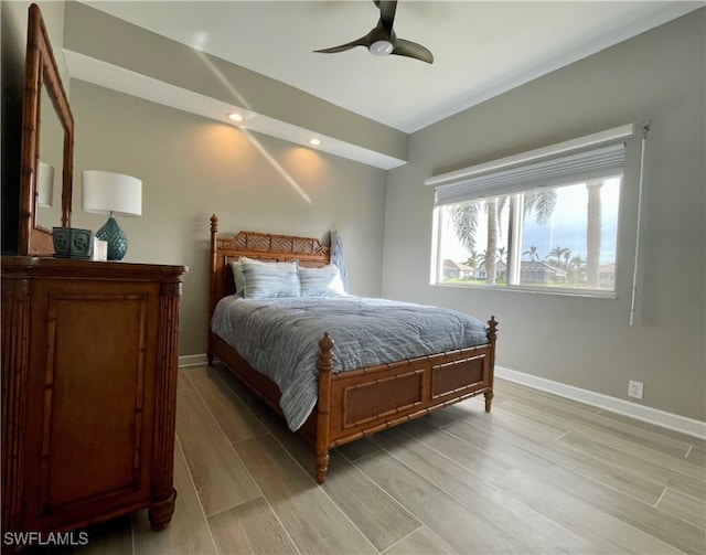 bedroom with ceiling fan and light hardwood / wood-style floors