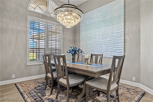 dining space with a chandelier and hardwood / wood-style flooring