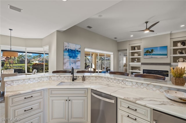 kitchen with sink, stainless steel dishwasher, ceiling fan, light stone countertops, and decorative light fixtures