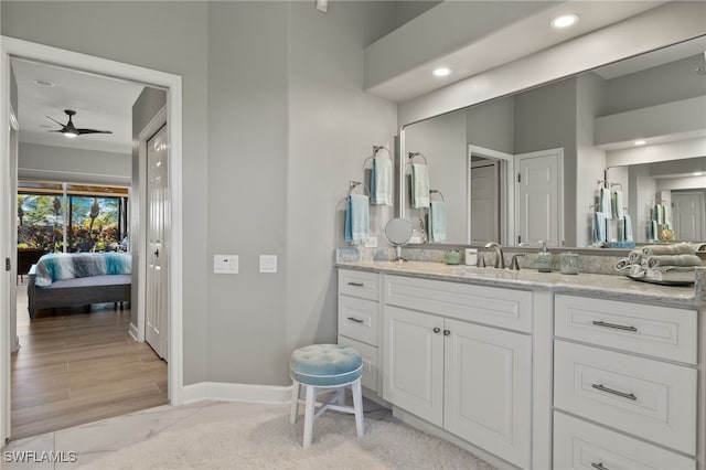 bathroom featuring ceiling fan, vanity, and wood-type flooring