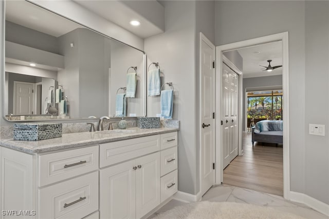 bathroom featuring ceiling fan, wood-type flooring, and vanity