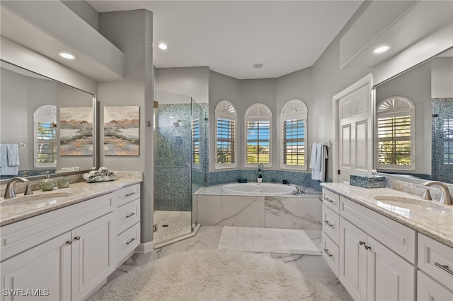 bathroom with vanity and independent shower and bath