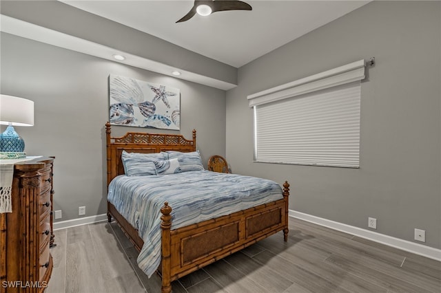 bedroom with ceiling fan and wood-type flooring