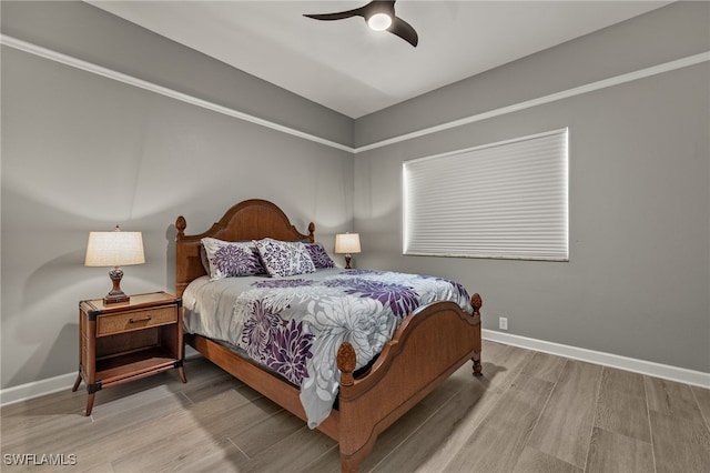 bedroom with ceiling fan and hardwood / wood-style floors