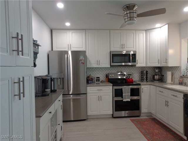 kitchen featuring white cabinetry, stainless steel appliances, and sink