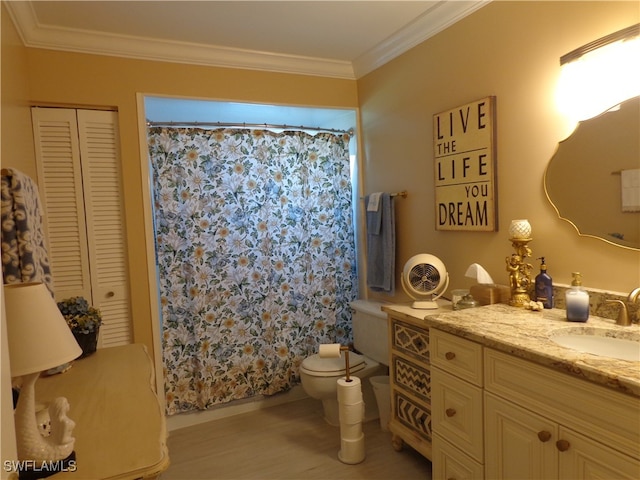 bathroom featuring vanity, toilet, crown molding, and walk in shower