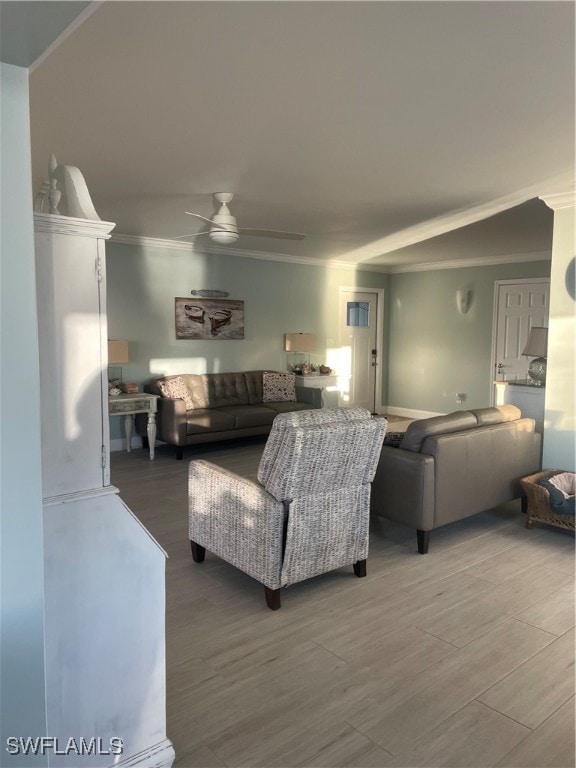 living room with ceiling fan, ornamental molding, and hardwood / wood-style floors