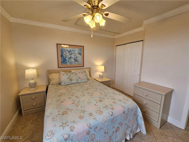 tiled bedroom featuring crown molding, a textured ceiling, a closet, and ceiling fan