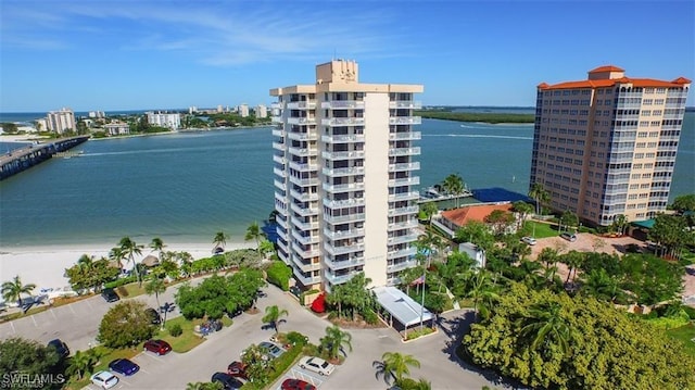 drone / aerial view with a beach view and a water view