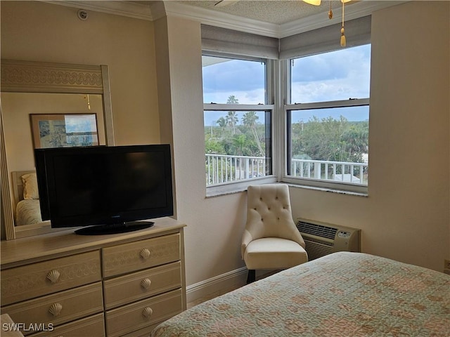 bedroom with ornamental molding and an AC wall unit