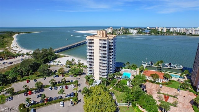 aerial view with a water view and a beach view