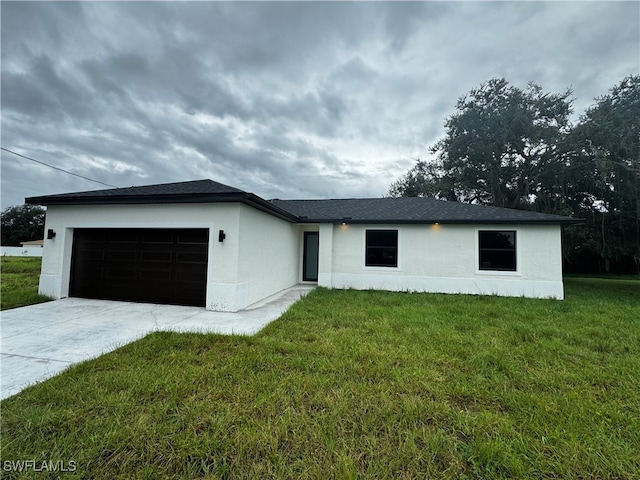 view of front of house with a front yard and a garage