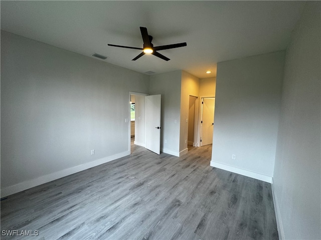 unfurnished bedroom with ceiling fan and light wood-type flooring