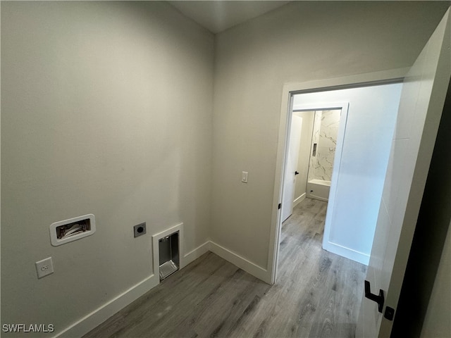 washroom featuring electric dryer hookup, light hardwood / wood-style flooring, and washer hookup