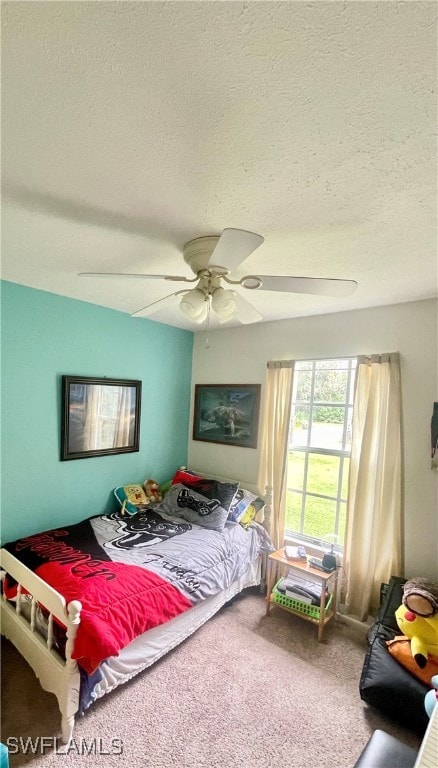 bedroom featuring carpet, ceiling fan, and a textured ceiling