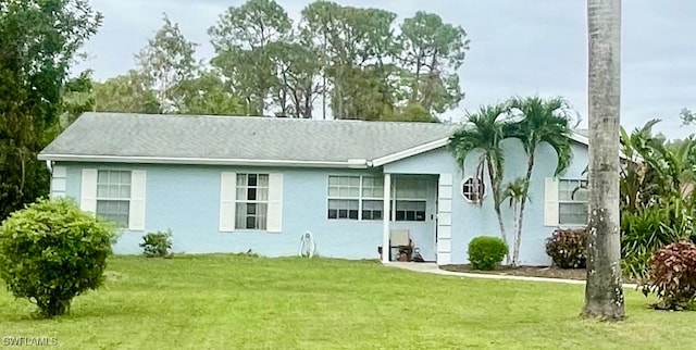 rear view of house with a yard