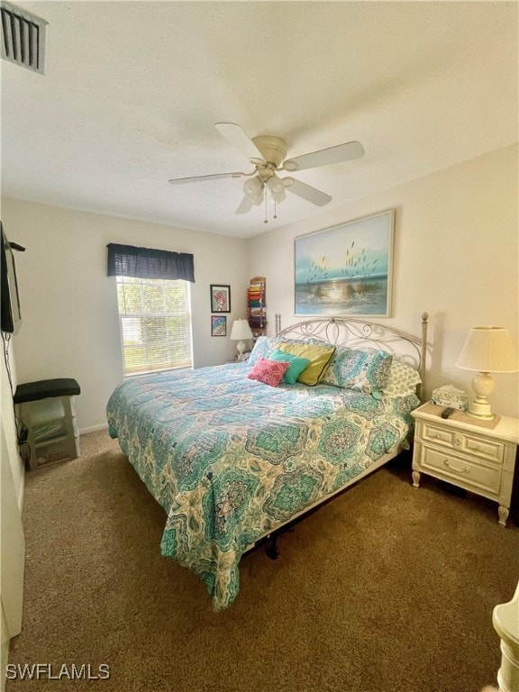 bedroom featuring ceiling fan and dark carpet