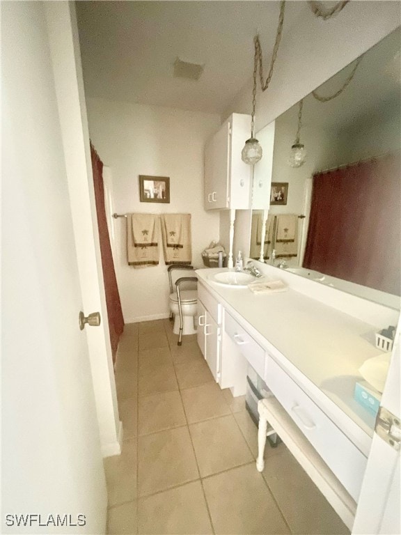 bathroom featuring toilet, vanity, and tile patterned floors