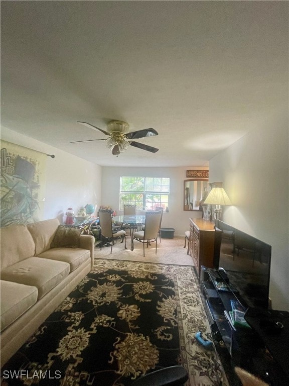 living room featuring carpet and ceiling fan