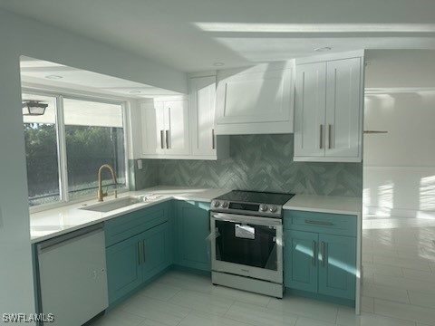 kitchen featuring white cabinetry, sink, premium range hood, white dishwasher, and stainless steel electric range