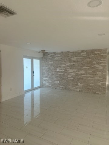 unfurnished room featuring light tile patterned floors and french doors