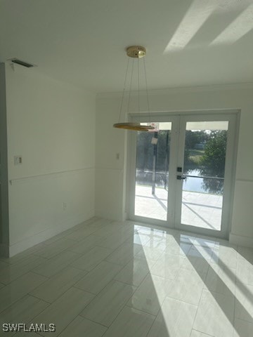 empty room with tile patterned floors and french doors