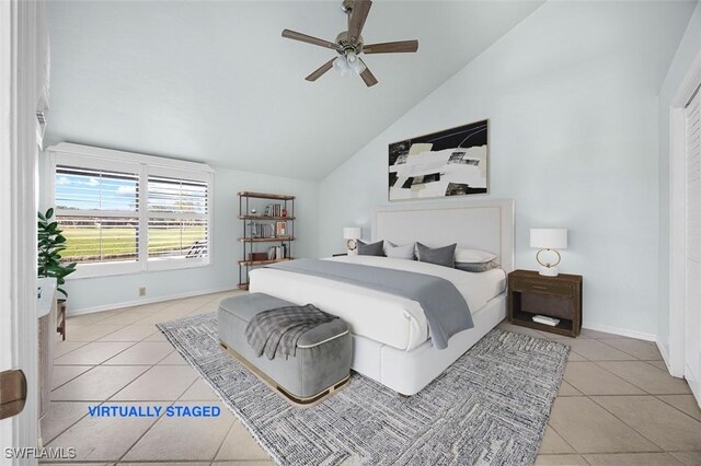 unfurnished room featuring lofted ceiling, light tile patterned floors, and ceiling fan