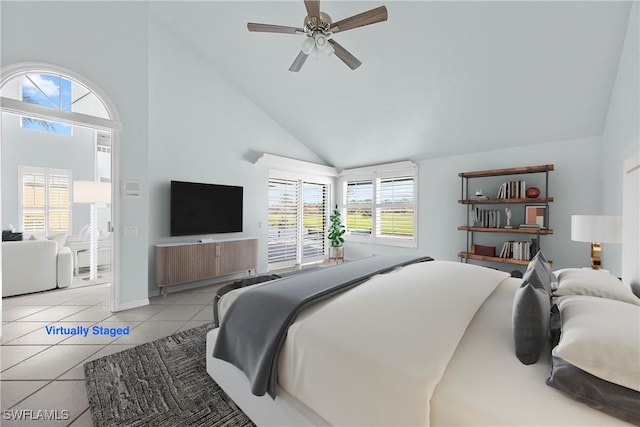 tiled bedroom with ceiling fan and high vaulted ceiling