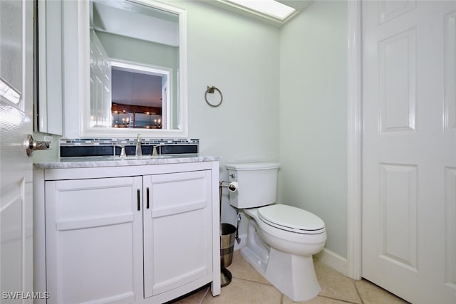 bathroom featuring tile patterned floors, vanity, and toilet