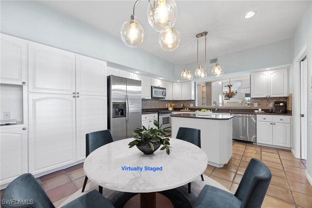 dining space featuring light tile patterned floors and sink