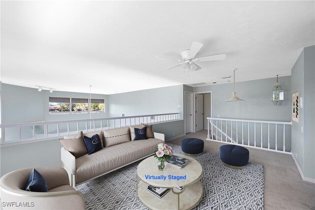 empty room featuring ceiling fan and light colored carpet