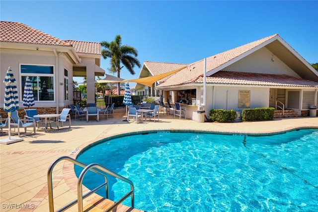 view of swimming pool featuring a patio area