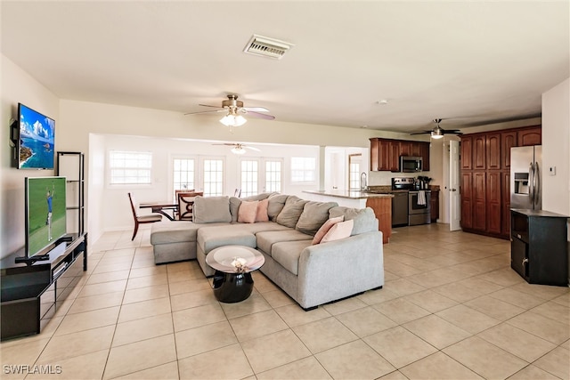 living room with sink, ceiling fan, and light tile patterned flooring