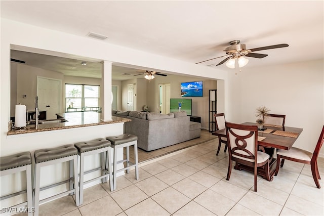 tiled dining room featuring sink and ceiling fan